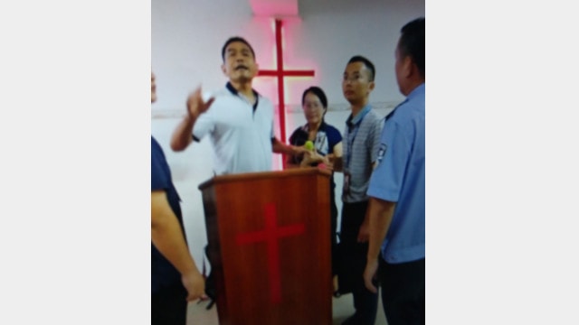 The police ordered Pastor Wang (the woman in the middle) to stop holding gatherings.
