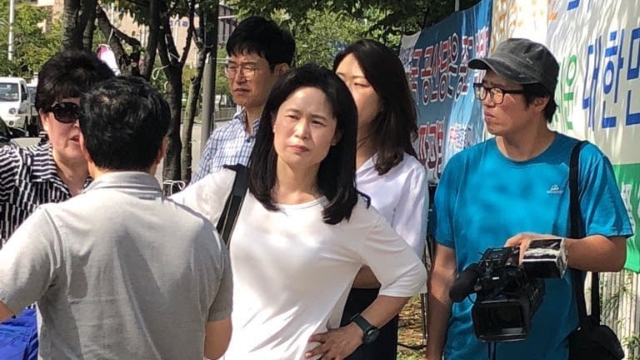 Ms. O during the false demonstration against The Church of Almighty God in Seoul