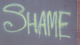 the word shame on a wall