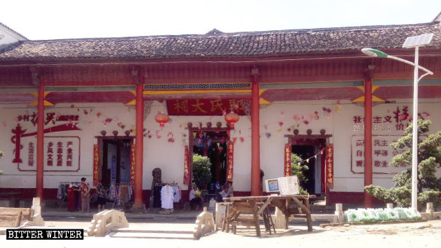 A banner calling “to revitalize rural areas” is posted inside the temple