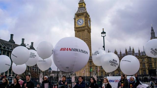 Protesters from Big Brother Watch, Stop Uyghur Genocide, and Free Tibet gathered with spoof “spy” balloons in front of the U.K. Parliament to protest the use of Chinese company Hikvision surveillance cameras in public buildings around the country. (Photo courtesy of Big Brother Watch).