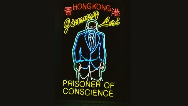 The neon sign “Jimmy Lai in Chains.”