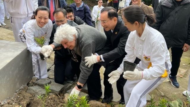 Eileen Barker plants her tree.