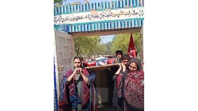 Daughters Sorath and Sassui carry the coffin of their father at the funeral. From X.