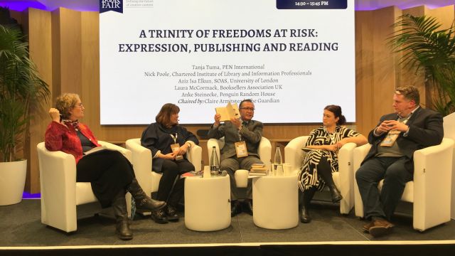 Left to right: Claire Armitstead Associate Editor, Culture, “The Guardian”; Tanja Tuma, Interim International Secretary, PEN International; Aziz Isa Elkun, Uyghur poet, sitting behind a pile of Uyghur books banned by the Chinese state in his homeland; Laura McCormack, Booksellers Association; Nick Poole, former CEO, Chartered Institute of Library and Information Professionals. Photo by Ruth Ingram