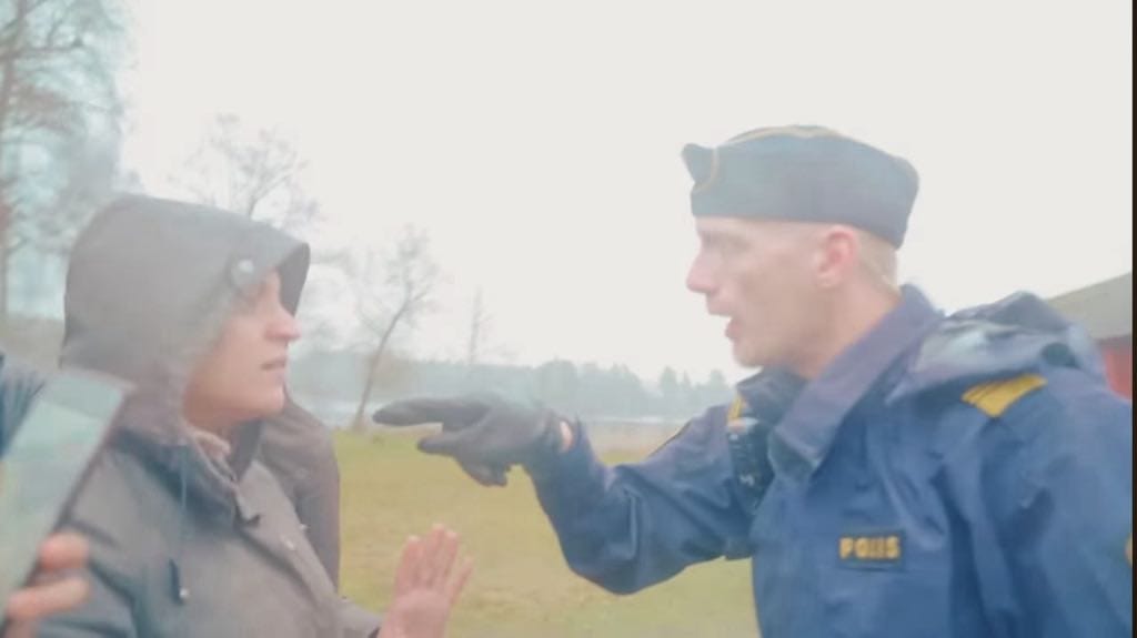 A Swedish police agent confronting an AROPL devotee during one of the raids in Sweden.