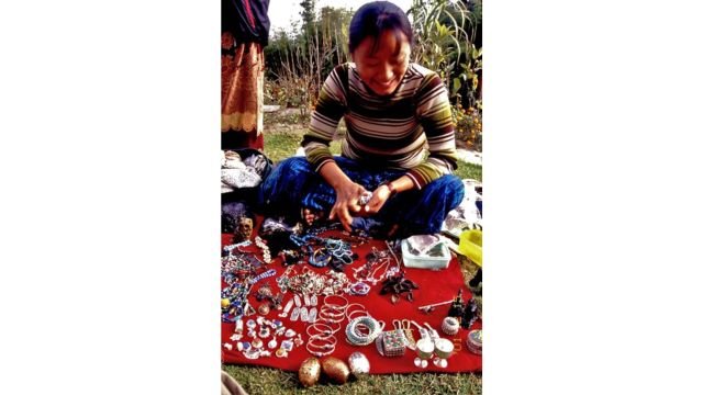 A Tibetan refugee selling traditional handicraft in Nepal. Credits. 