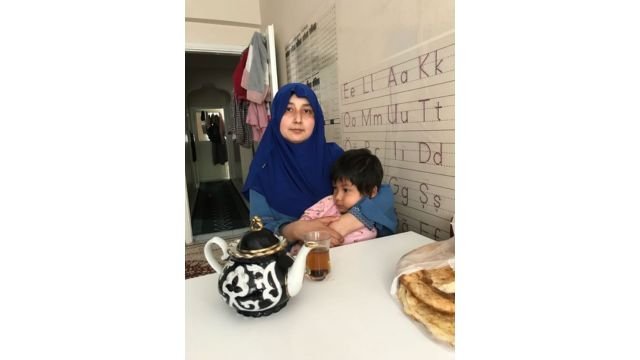 Zeynure, Idris Hasan’s wife, at home in Istanbul with her youngest daughter, Uyghuray. Photo by Ruth Ingram.