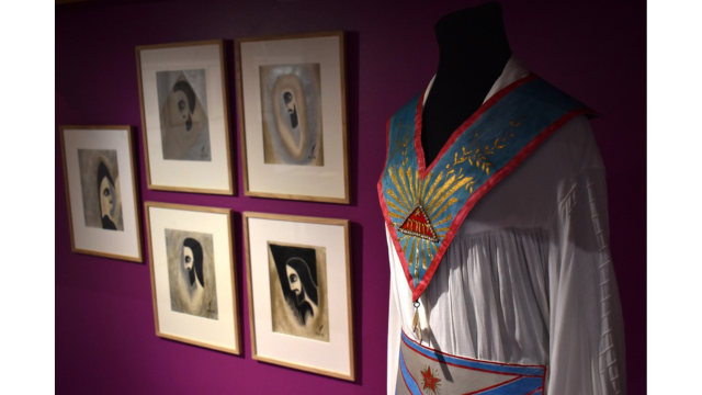 On the left: Ionowa’s self-portrait titled “Tekijälle” and her Masters-series depicting Saint Germain, Christ, Mahatmas Moria and Koot Hoomi, from 1952. On the right: Ruusu-Risti ritual gown and regalia made by Ionowa and Selma Mäkelä.