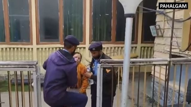 Police assist a survivor of the attack. Screenshot.