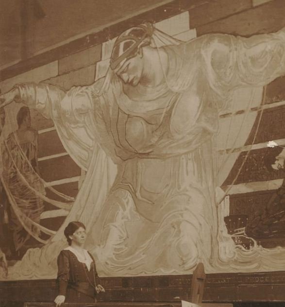 Oakley working at her “Unity” mural. From X.