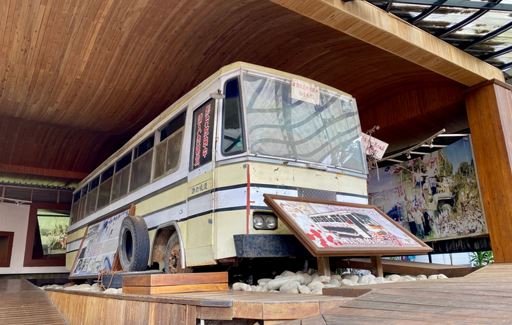 A church bus vandalized during the police raid on Mount Zion, now on display as evidence of the persecution.