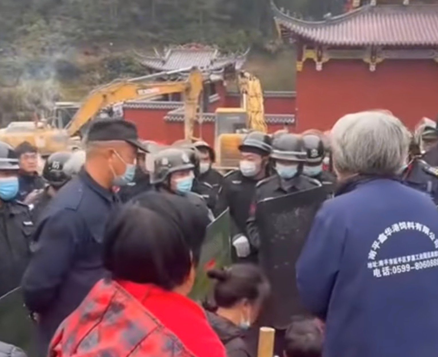 Villagers confront the police.