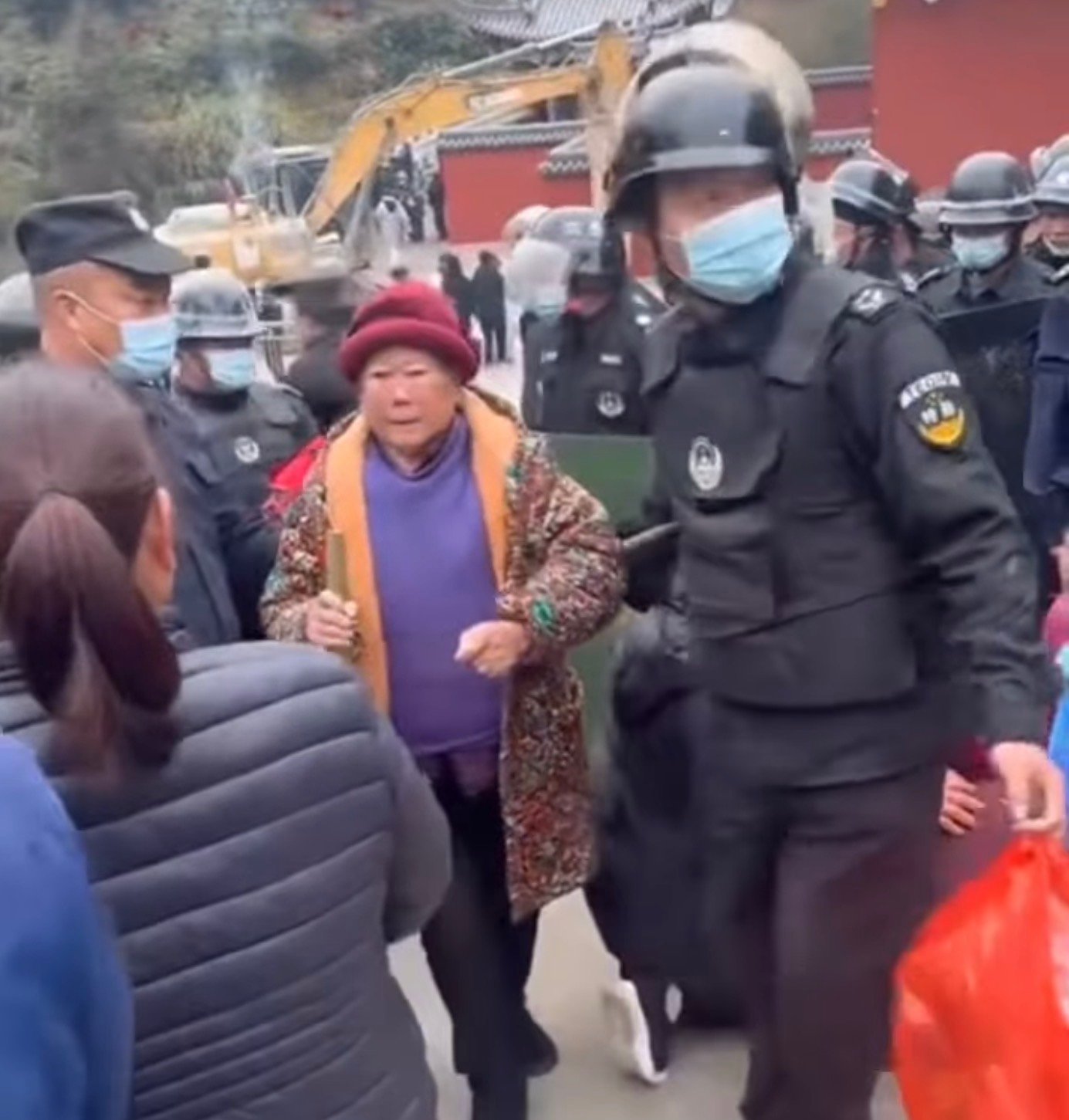 An older woman is arrested.