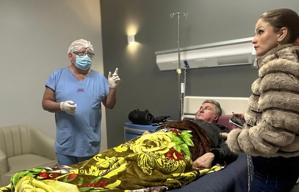 Konstantin Rudnev in the hospital, assisted by his wife.
