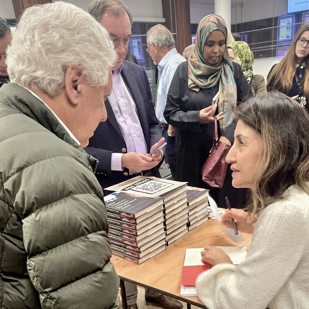 Hamid Sabi (left), human rights lawyer and former Counsel to the Uyghur Tribunal in London, with Gulbahar Haitiwaji signing a copy of her book, &ldquo;How I Survived a Chinese Re-Education Camp.&rdquo; Credits: Stop Uyghur Genocide.